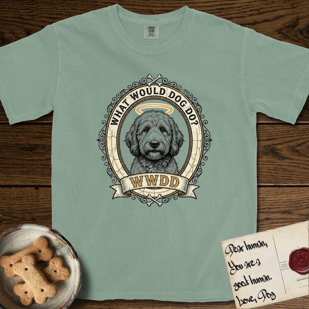 What Would Dog Do Goldendoodle T-Shirt flat lay in Bay, featuring an ornate scrollwork gold portrait medallion of a haloed Goldendoodle with the question What Would Dog Do.