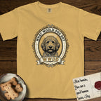 What Would Dog Do Goldendoodle T-Shirt flat lay in Mustard, featuring an ornate scrollwork gold portrait medallion of a haloed Goldendoodle with the question What Would Dog Do.
