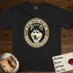 What Would Dog Do Husky T-Shirt flat lay in Black, featuring a vintage gold portrait medallion of a haloed blue-eyed Husky in a Nordic snowflake border with the question What Would Dog Do.