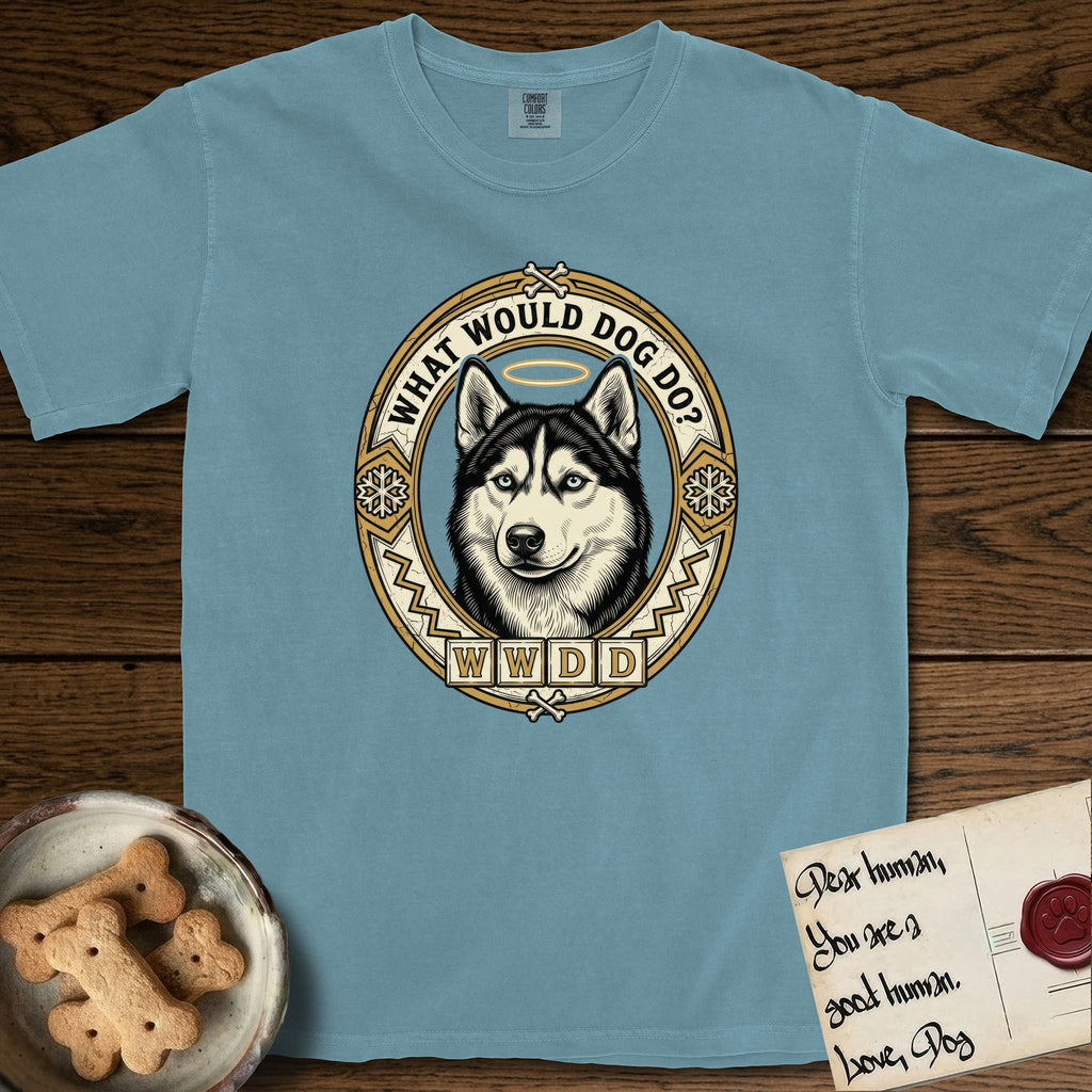 What Would Dog Do Husky T-Shirt flat lay in Ice Blue, featuring a vintage gold portrait medallion of a haloed blue-eyed Husky in a Nordic snowflake border with the question What Would Dog Do.