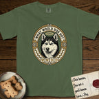 What Would Dog Do Husky T-Shirt flat lay in Moss, featuring a vintage gold portrait medallion of a haloed blue-eyed Husky in a Nordic snowflake border with the question What Would Dog Do.