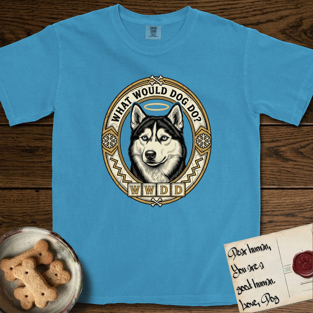 What Would Dog Do Husky T-Shirt flat lay in Royal Caribe, featuring a vintage gold portrait medallion of a haloed blue-eyed Husky in a Nordic snowflake border with the question What Would Dog Do.
