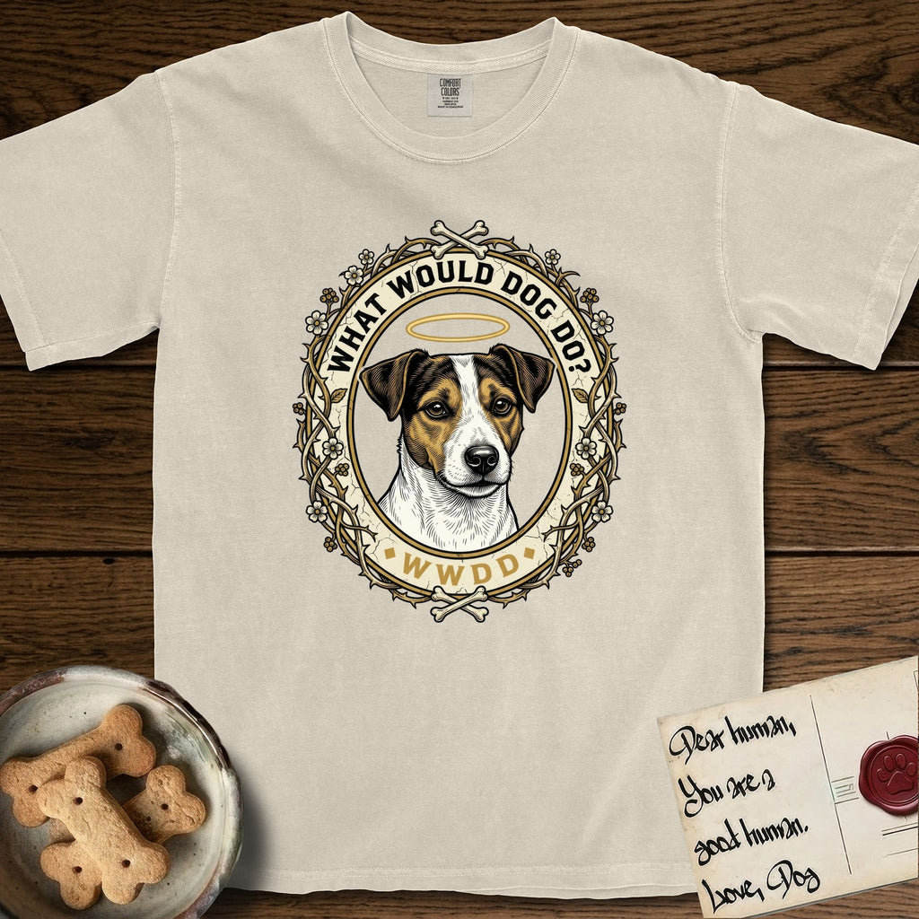 What Would Dog Do Jack Russell T-Shirt flat lay in Ivory, featuring a vintage gold portrait medallion of a haloed Jack Russell in a wreath of thorned branches and wildflowers with the question What Would Dog Do.