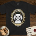 What Would Dog Do Maltese T-Shirt flat lay in Black, featuring a vintage gold portrait medallion of a haloed white Maltese in a Celtic knotwork and rope border with the question What Would Dog Do.