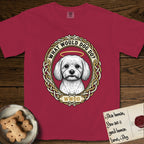 What Would Dog Do Maltese T-Shirt flat lay in Chili, featuring a vintage gold portrait medallion of a haloed white Maltese in a Celtic knotwork and rope border with the question What Would Dog Do.