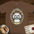 What Would Dog Do Maltese T-Shirt flat lay in Espresso, featuring a vintage gold portrait medallion of a haloed white Maltese in a Celtic knotwork and rope border with the question What Would Dog Do.