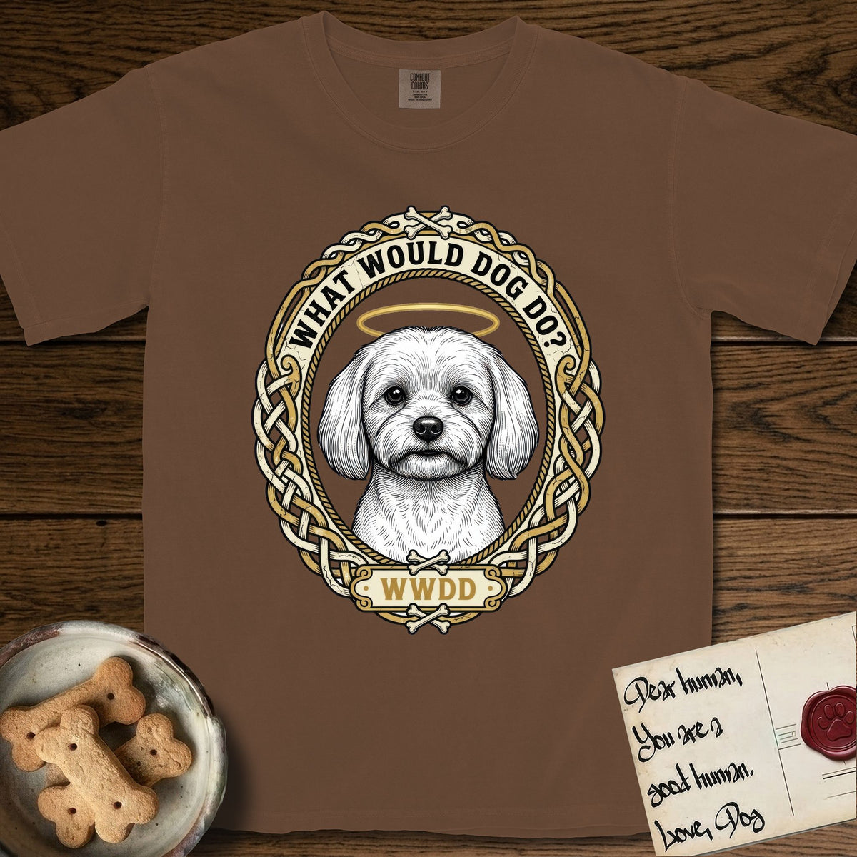 What Would Dog Do Maltese T-Shirt flat lay in Espresso, featuring a vintage gold portrait medallion of a haloed white Maltese in a Celtic knotwork and rope border with the question What Would Dog Do.
