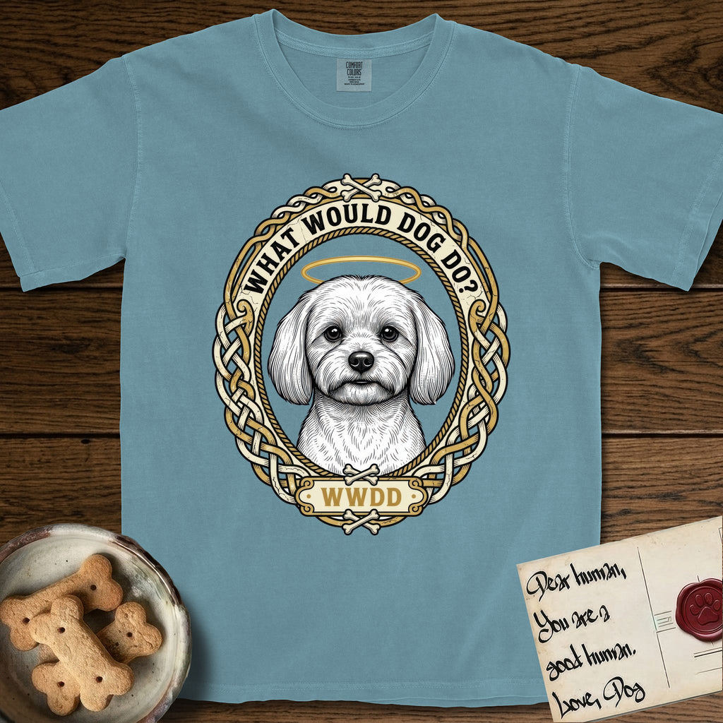 What Would Dog Do Maltese T-Shirt flat lay in Ice Blue, featuring a vintage gold portrait medallion of a haloed white Maltese in a Celtic knotwork and rope border with the question What Would Dog Do.