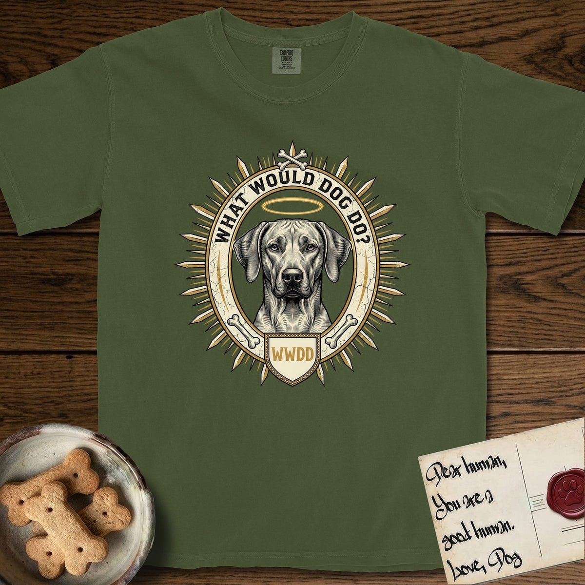 What Would Dog Do Rhodesian Ridgeback T-Shirt flat lay in Hemp, featuring a vintage gold portrait medallion of a haloed Rhodesian Ridgeback ringed by radiating sunburst spikes with the question What Would Dog Do.
