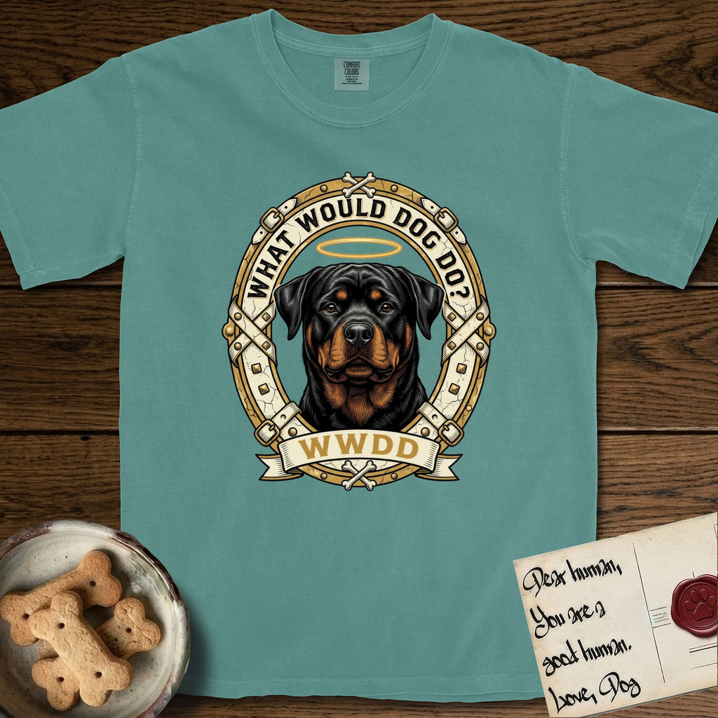 What Would Dog Do Rottweiler T-Shirt flat lay in Blue Spruce, featuring a vintage gold portrait medallion of a haloed Rottweiler framed by studded leather collar straps and buckles with the question What Would Dog Do.