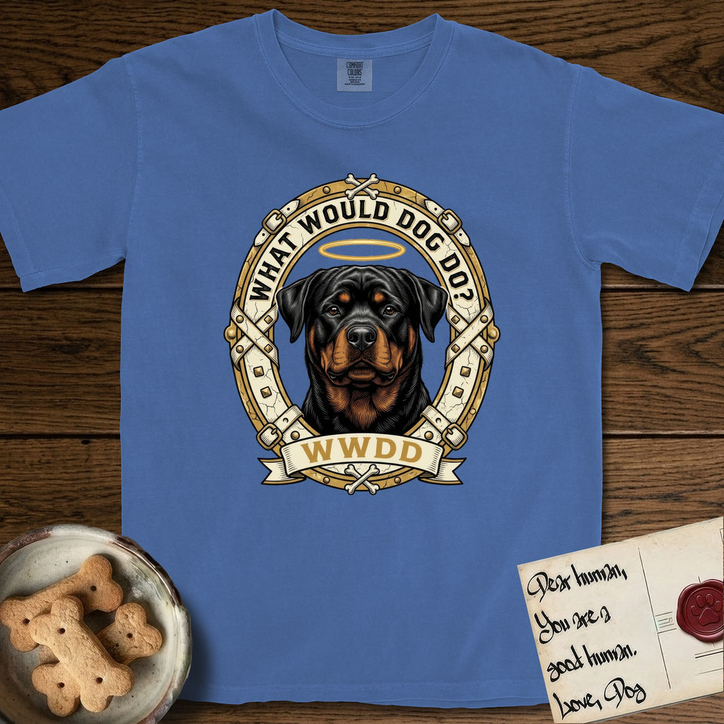 What Would Dog Do Rottweiler T-Shirt flat lay in Mystic Blue, featuring a vintage gold portrait medallion of a haloed Rottweiler framed by studded leather collar straps and buckles with the question What Would Dog Do.
