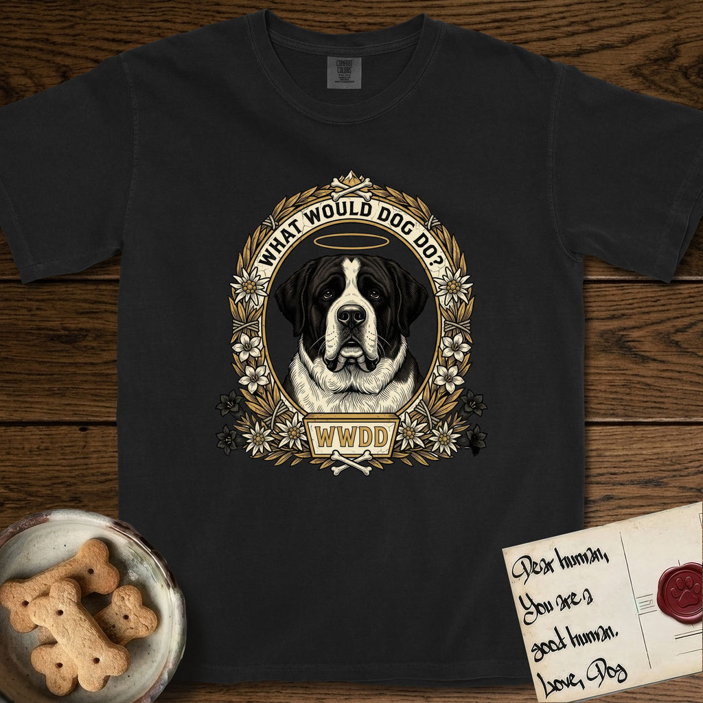 What Would Dog Do Saint Bernard T-Shirt flat lay in Black, featuring a vintage gold portrait medallion of a haloed Saint Bernard in an alpine laurel wreath with edelweiss blossoms and the question What Would Dog Do.