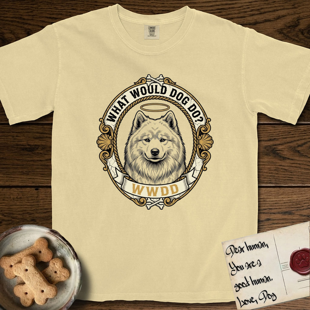 What Would Dog Do Samoyed T-Shirt flat lay in Butter, featuring a rope-twist framed gold portrait medallion of a haloed Samoyed with the question What Would Dog Do.