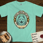 What Would Dog Do Samoyed T-Shirt flat lay in Island Reef, featuring a rope-twist framed gold portrait medallion of a haloed Samoyed with the question What Would Dog Do.