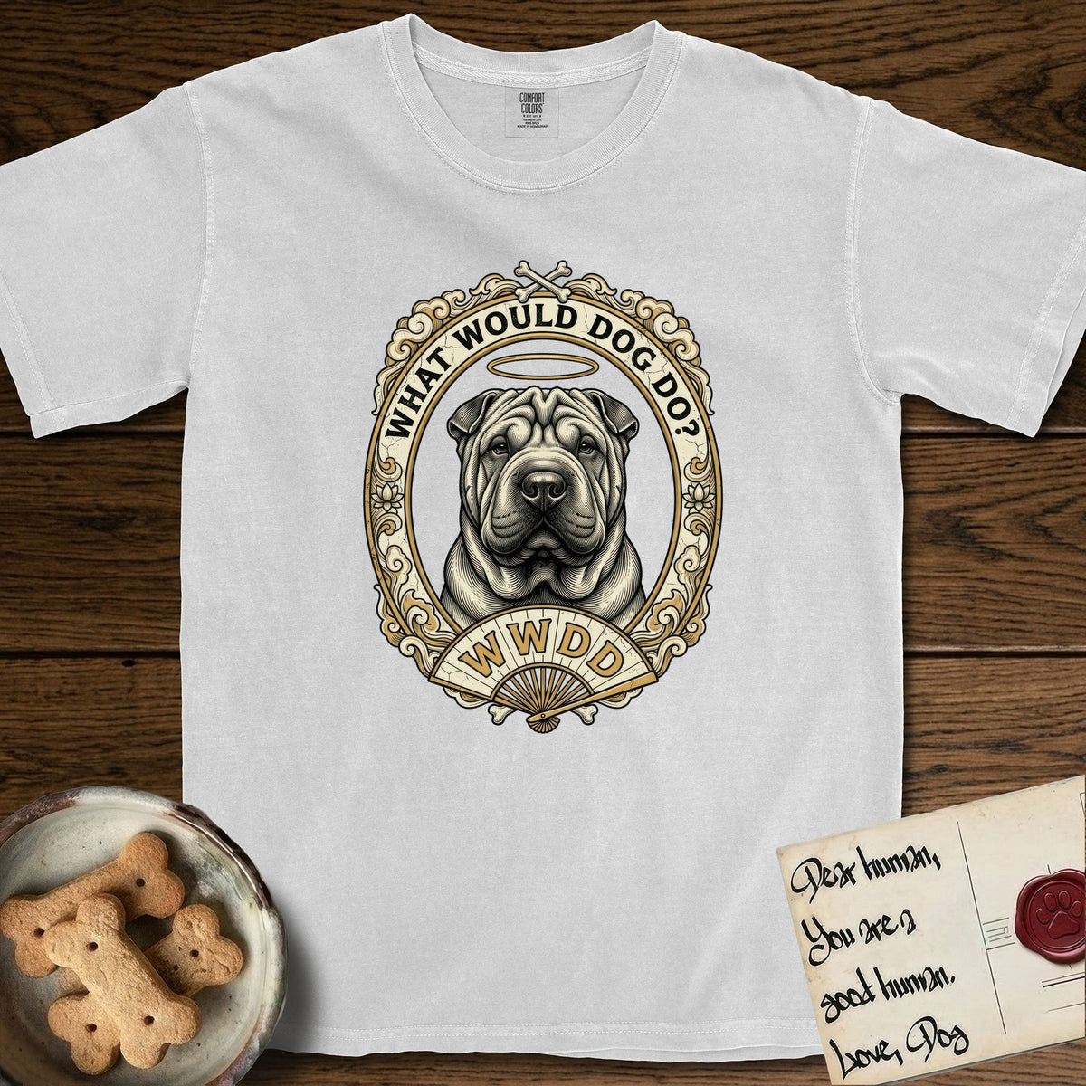 What Would Dog Do Shar-Pei T-Shirt flat lay in White, featuring a vintage gold portrait medallion of a haloed wrinkled Shar-Pei in an ornate scrolled frame with a folding fan banner and the question What Would Dog Do.