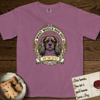 What Would Dog Do Cavalier T-Shirt flat lay in Berry, featuring a rose-bordered gold portrait medallion of a haloed Cavalier King Charles Spaniel with the question What Would Dog Do.