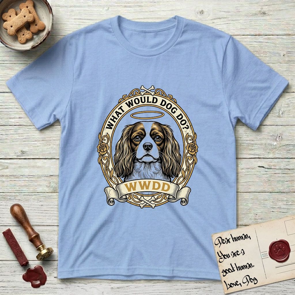 What Would Dog Do Spaniel T-Shirt flat lay in Light Blue, featuring a rose-bordered gold portrait medallion of a haloed Cavalier King Charles Spaniel with the question What Would Dog Do.