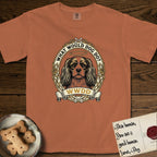 What Would Dog Do Cavalier T-Shirt flat lay in Yam, featuring a rose-bordered gold portrait medallion of a haloed Cavalier King Charles Spaniel with the question What Would Dog Do.
