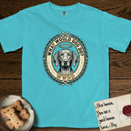 What Would Dog Do Vizsla T-Shirt flat lay in Lagoon Blue, featuring a laurel-wreath framed gold portrait medallion of a haloed Vizsla with the question What Would Dog Do.