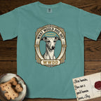 What Would Dog Do Whippet T-Shirt flat lay in Blue Spruce, featuring a vintage gold portrait medallion of a haloed Whippet in an Art Deco stepped frame with the question What Would Dog Do.