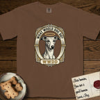 What Would Dog Do Whippet T-Shirt flat lay in Espresso, featuring a vintage gold portrait medallion of a haloed Whippet in an Art Deco stepped frame with the question What Would Dog Do.