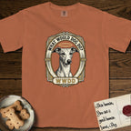 What Would Dog Do Whippet T-Shirt flat lay in Yam, featuring a vintage gold portrait medallion of a haloed Whippet in an Art Deco stepped frame with the question What Would Dog Do.